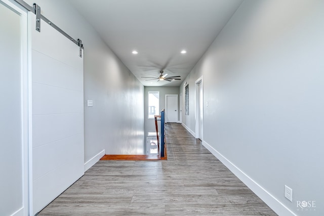 4992 Silver Creek Pass, San Angelo, TX 76904 - corridor with a barn door, recessed lighting, and light wood-type flooring