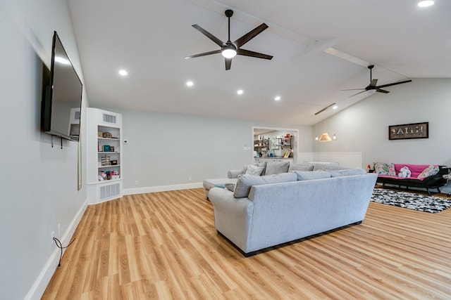 living room featuring ceiling fan, lofted ceiling, and light wood-type flooring