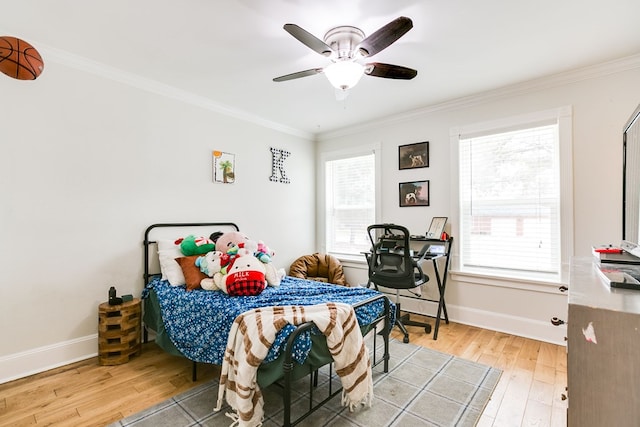 bedroom featuring hardwood / wood-style flooring, ornamental molding, and ceiling fan