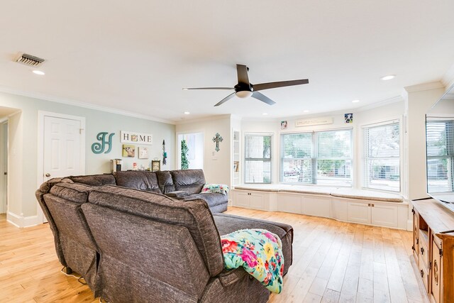 living room with crown molding, ceiling fan, and light wood-type flooring