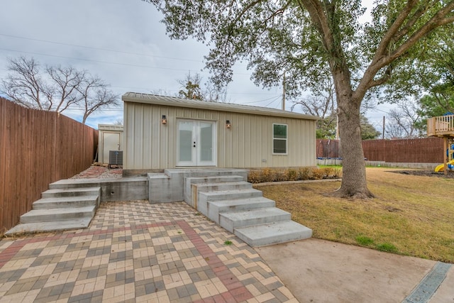 rear view of house featuring central AC, a patio area, and french doors