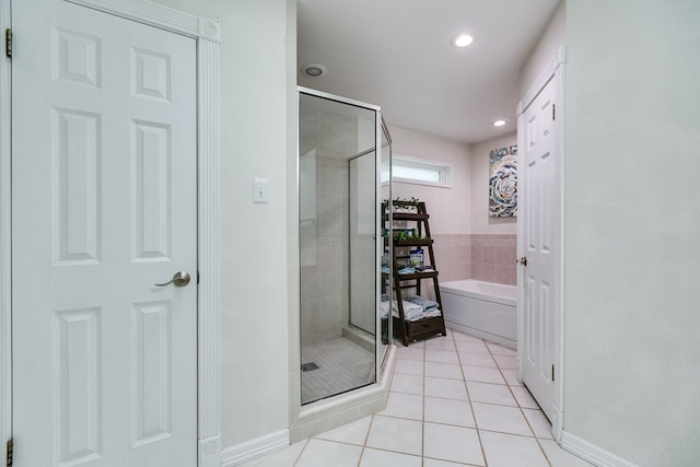 bathroom with independent shower and bath and tile patterned floors