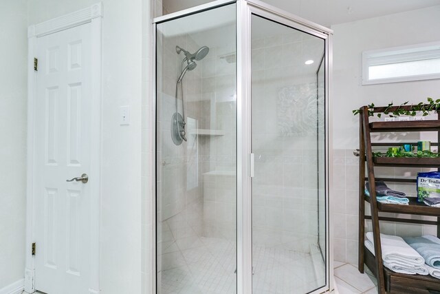 bathroom featuring a shower with door