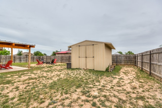 7805 Elk Run, San Angelo, TX 76901 - fenced backyard featuring a shed, an outbuilding, and a patio area