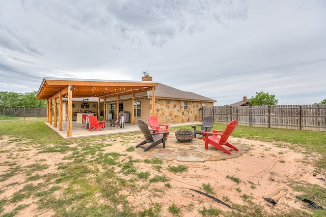 7805 Elk Run, San Angelo, TX 76901 - fenced backyard featuring an outdoor fire pit and a patio area