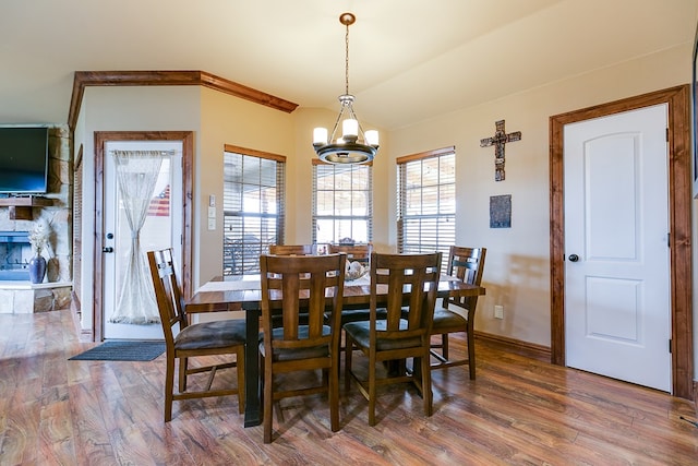 7805 Elk Run, San Angelo, TX 76901 - dining area with a chandelier, wood finished floors, and baseboards