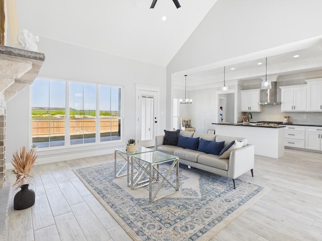 3725 Silver Spur Dr, San Angelo, TX 76904 - living area with high vaulted ceiling, ceiling fan, light wood-style floors, a chandelier, and recessed lighting