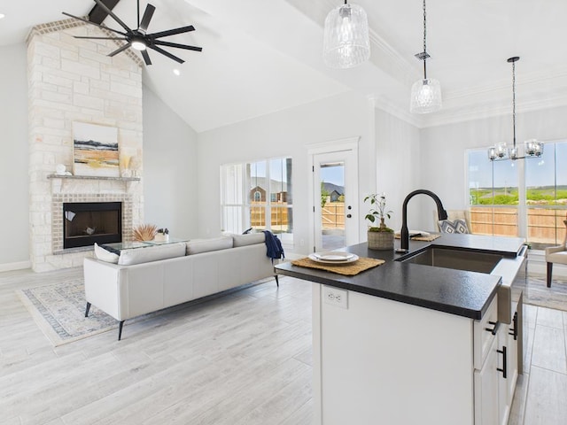 3725 Silver Spur Dr, San Angelo, TX 76904 - kitchen featuring dark countertops, ceiling fan, a sink, open floor plan, and high vaulted ceiling