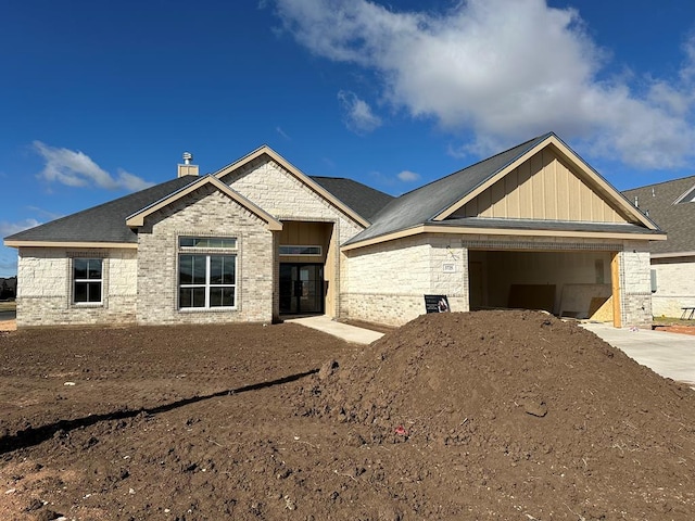 3725 Silver Spur Dr, San Angelo, TX 76904 - view of front of home with a garage, driveway, and a chimney