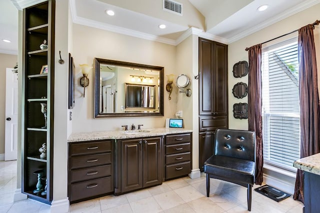 5202 Beverly Dr, San Angelo, TX 76904 - bathroom with crown molding, vanity, lofted ceiling, baseboards, and tile patterned floors
