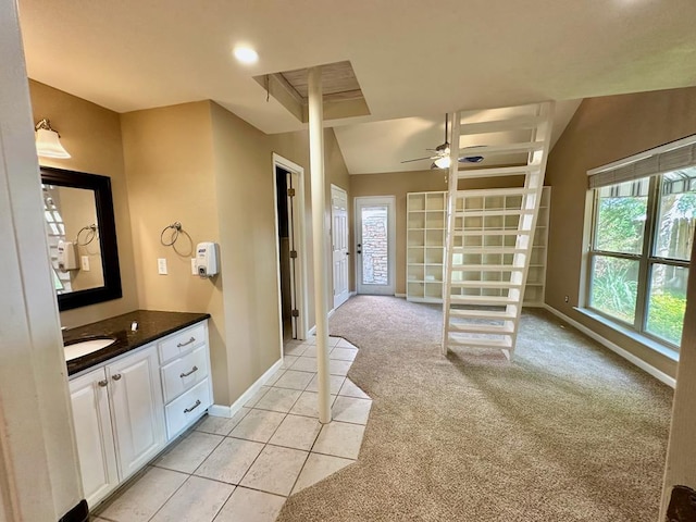 5202 Beverly Dr, San Angelo, TX 76904 - bathroom with a ceiling fan, baseboards, vanity, vaulted ceiling, and tile patterned flooring