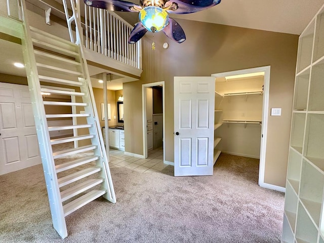 5202 Beverly Dr, San Angelo, TX 76904 - interior space with ceiling fan, carpet, a high ceiling, baseboards, and tile patterned flooring