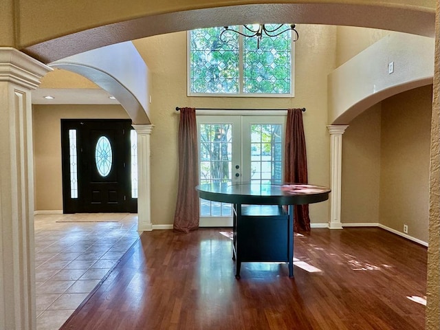 5202 Beverly Dr, San Angelo, TX 76904 - entrance foyer featuring baseboards, wood finished floors, a towering ceiling, a chandelier, and a textured wall