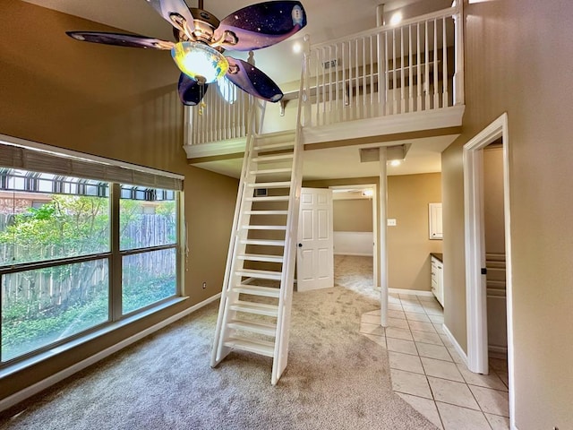 5202 Beverly Dr, San Angelo, TX 76904 - unfurnished bedroom with a high ceiling, light colored carpet, light tile patterned floors, and baseboards