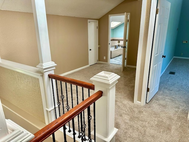 5202 Beverly Dr, San Angelo, TX 76904 - hallway with carpet floors, lofted ceiling, and baseboards