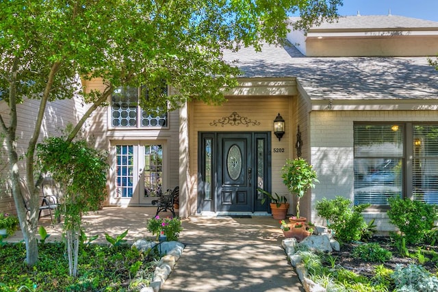 5202 Beverly Dr, San Angelo, TX 76904 - doorway to property with brick siding, french doors, and a shingled roof
