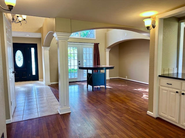 5202 Beverly Dr, San Angelo, TX 76904 - entryway with arched walkways, decorative columns, dark wood-type flooring, and baseboards