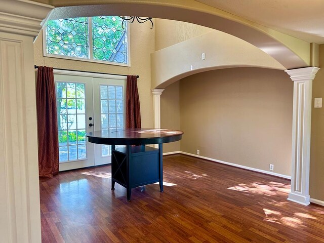 5202 Beverly Dr, San Angelo, TX 76904 - dining room with decorative columns, wood finished floors, arched walkways, and french doors
