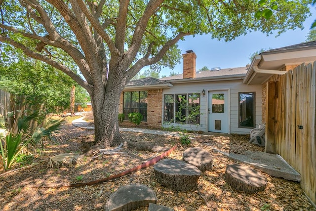  - rear view of property with a chimney