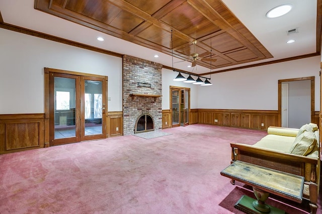  - living area with wainscoting, recessed lighting, a fireplace, a ceiling fan, and carpet flooring
