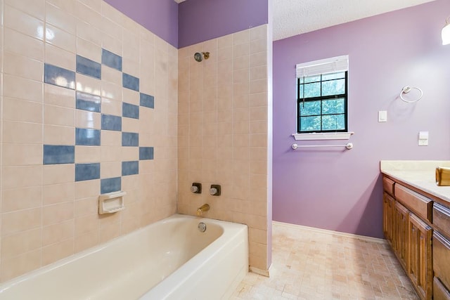 - full bath featuring vanity, baseboards, and shower / tub combination