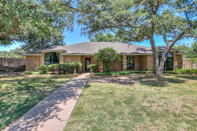 - view of front of property featuring brick siding and a shingled roof