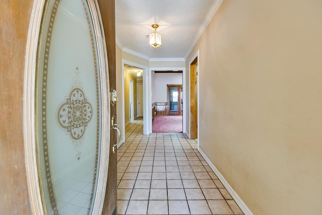  - corridor featuring ornamental molding, a textured ceiling, light tile patterned floors, and baseboards