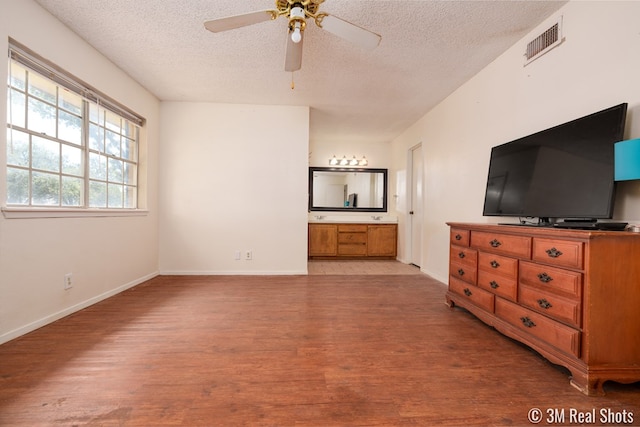 3317 Rockbrook Dr, San Angelo, TX 76904 - unfurnished bedroom with a textured ceiling, light wood-style flooring, and ensuite bathroom