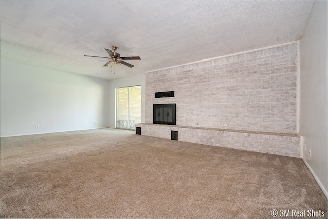 3317 Rockbrook Dr, San Angelo, TX 76904 - unfurnished living room with carpet flooring, ceiling fan, a fireplace, and a textured ceiling