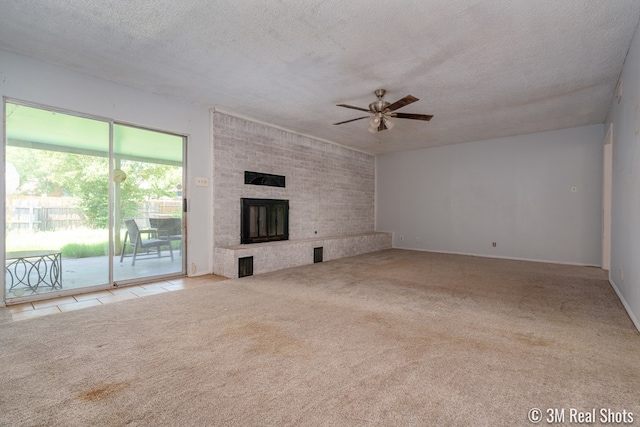 3317 Rockbrook Dr, San Angelo, TX 76904 - unfurnished living room with ceiling fan, carpet floors, a textured ceiling, and a fireplace