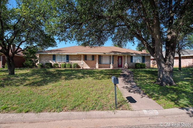3317 Rockbrook Dr, San Angelo, TX 76904 - ranch-style house with a front lawn, brick siding, and covered porch