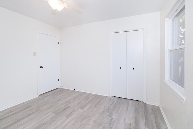 2007 Stanton St, Brady, TX 76825 - unfurnished bedroom with light wood-type flooring, a closet, baseboards, and a ceiling fan