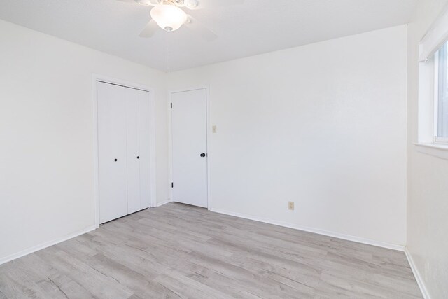 2007 Stanton St, Brady, TX 76825 - unfurnished bedroom featuring light wood-style floors, a closet, baseboards, and a ceiling fan