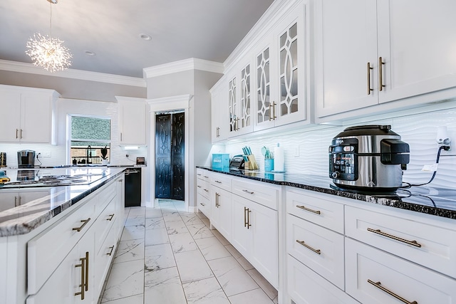 kitchen with white cabinetry, dark stone countertops, and backsplash