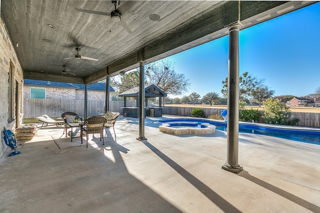 view of patio with a swimming pool with hot tub and ceiling fan