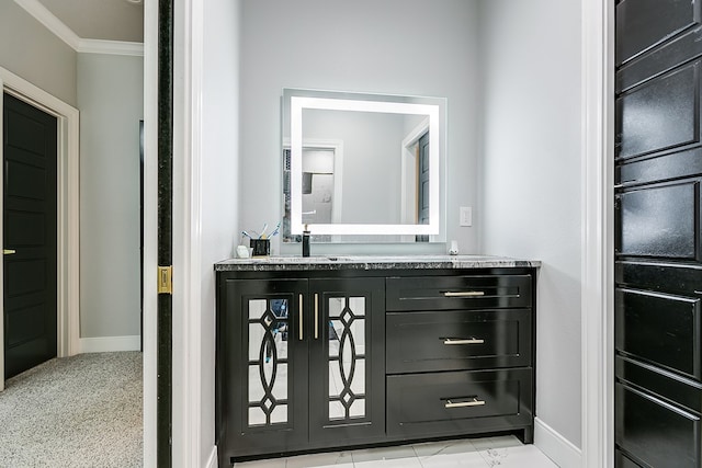 bathroom featuring crown molding and vanity