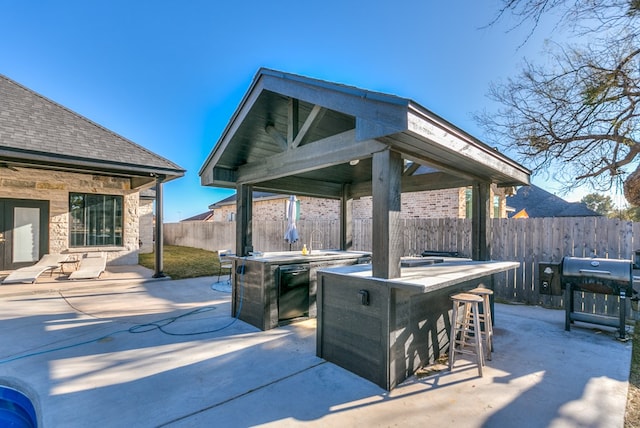 view of patio / terrace with a bar and a grill