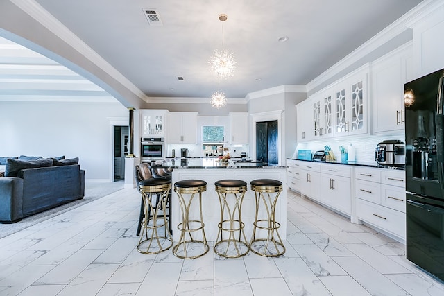 kitchen featuring white cabinetry, a center island, and pendant lighting