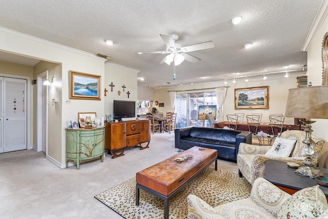 living area featuring a textured ceiling, light carpet, ceiling fan, and ornamental molding