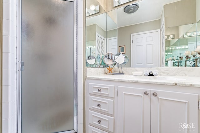 full bath featuring vanity, ornamental molding, and a stall shower