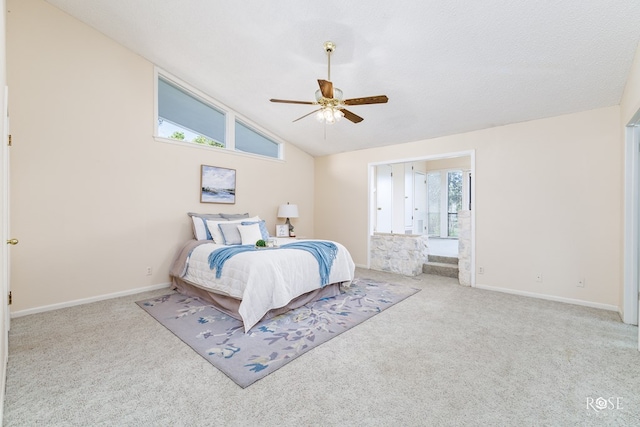 bedroom with lofted ceiling, a textured ceiling, light carpet, and ceiling fan