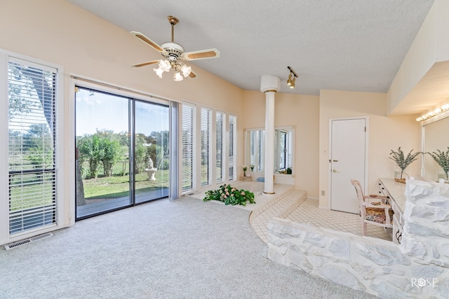 carpeted bedroom with ceiling fan, lofted ceiling, a textured ceiling, and access to outside