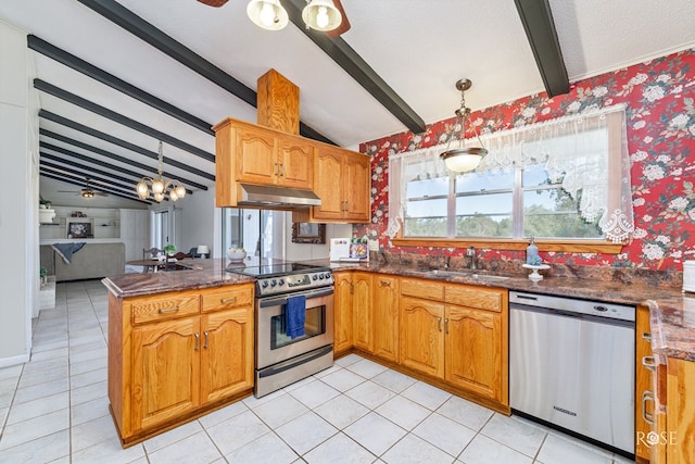 kitchen with sink, appliances with stainless steel finishes, hanging light fixtures, lofted ceiling with beams, and kitchen peninsula