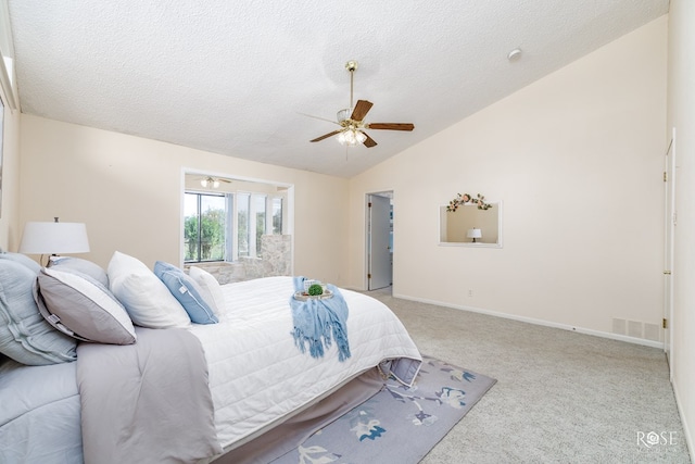 bedroom with ceiling fan, lofted ceiling, light colored carpet, and a textured ceiling