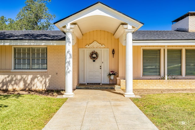 doorway to property with a yard