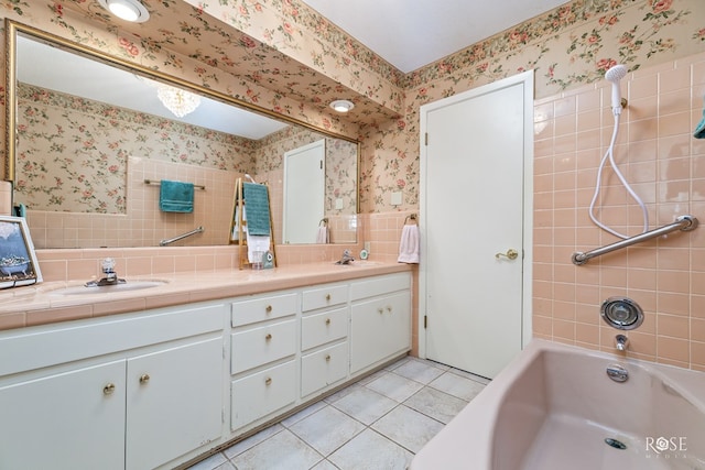 bathroom with vanity, tile patterned floors, and tiled shower / bath