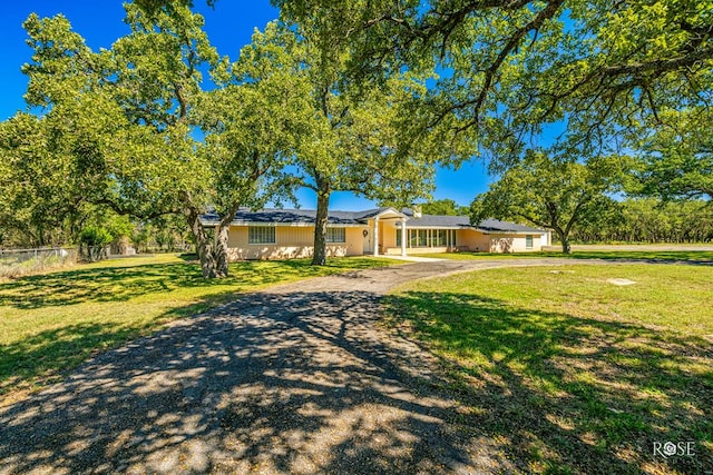 ranch-style house with a front yard