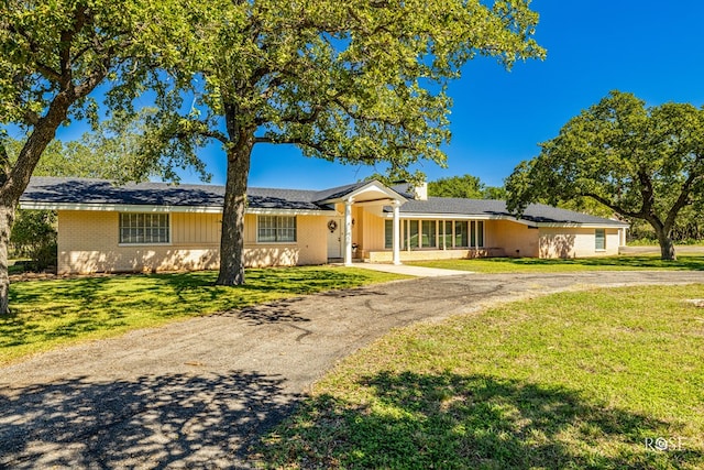 ranch-style home featuring a front yard