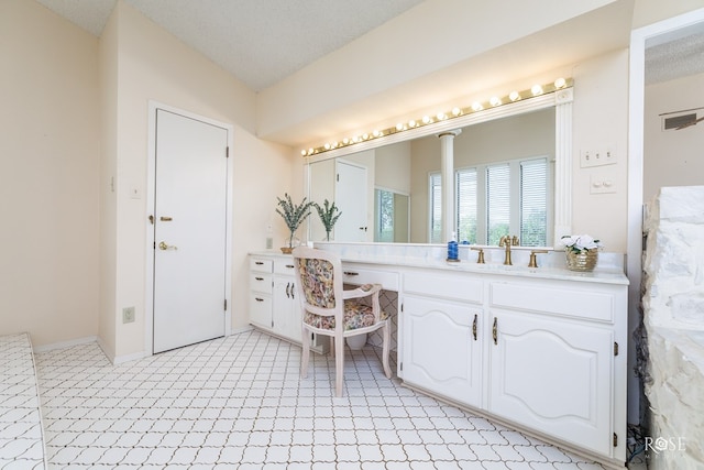 bathroom with vanity and a textured ceiling