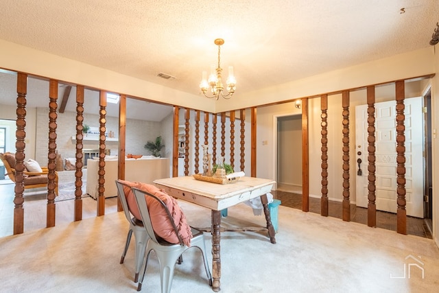 3302 Southland Blvd, San Angelo, TX 76904 - dining space featuring a chandelier, carpet flooring, and a textured ceiling